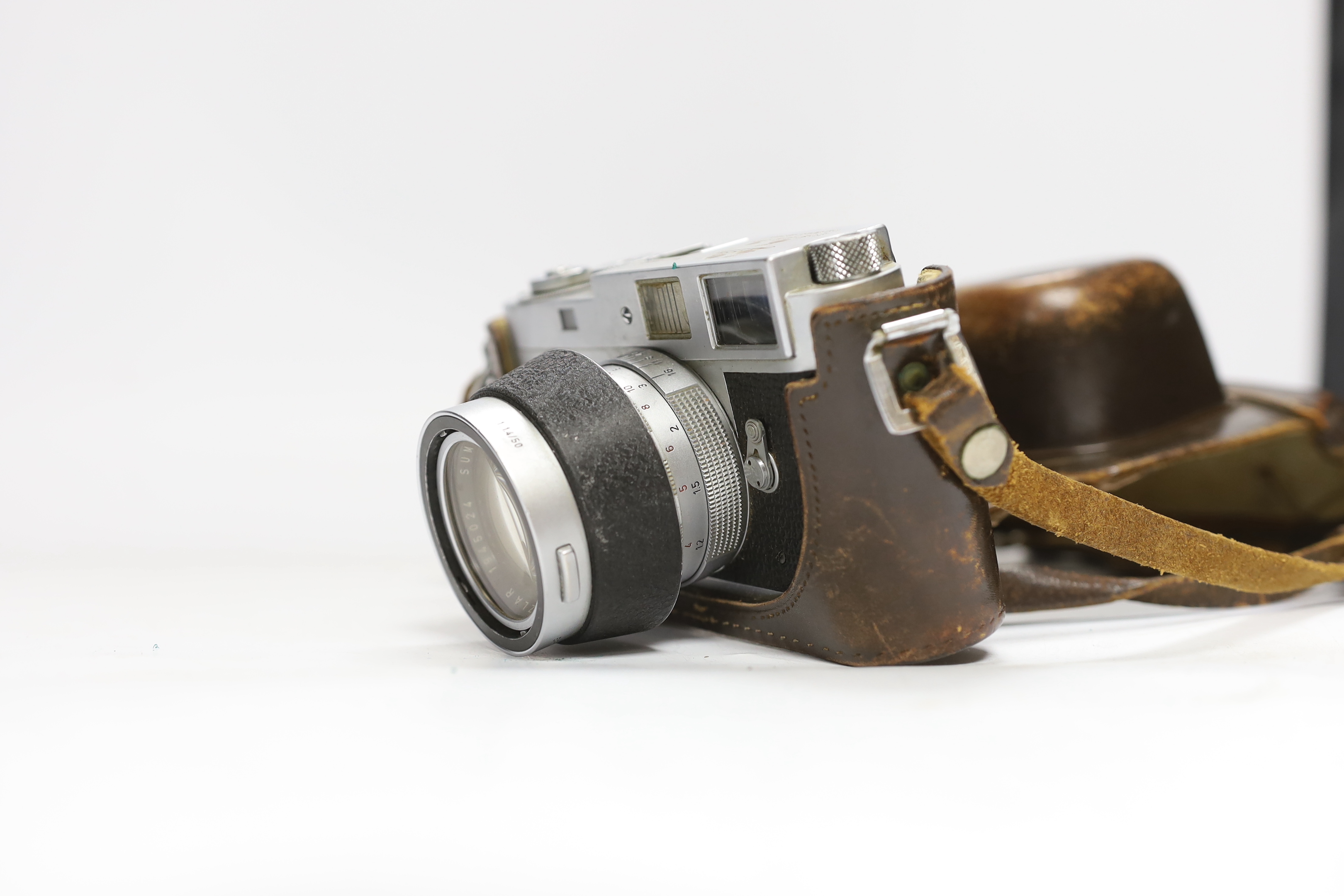 A Leica M2 camera, serial no. 982947, c. 1959, with Summilux 1:1. 4/50 lens, in leather case with strap